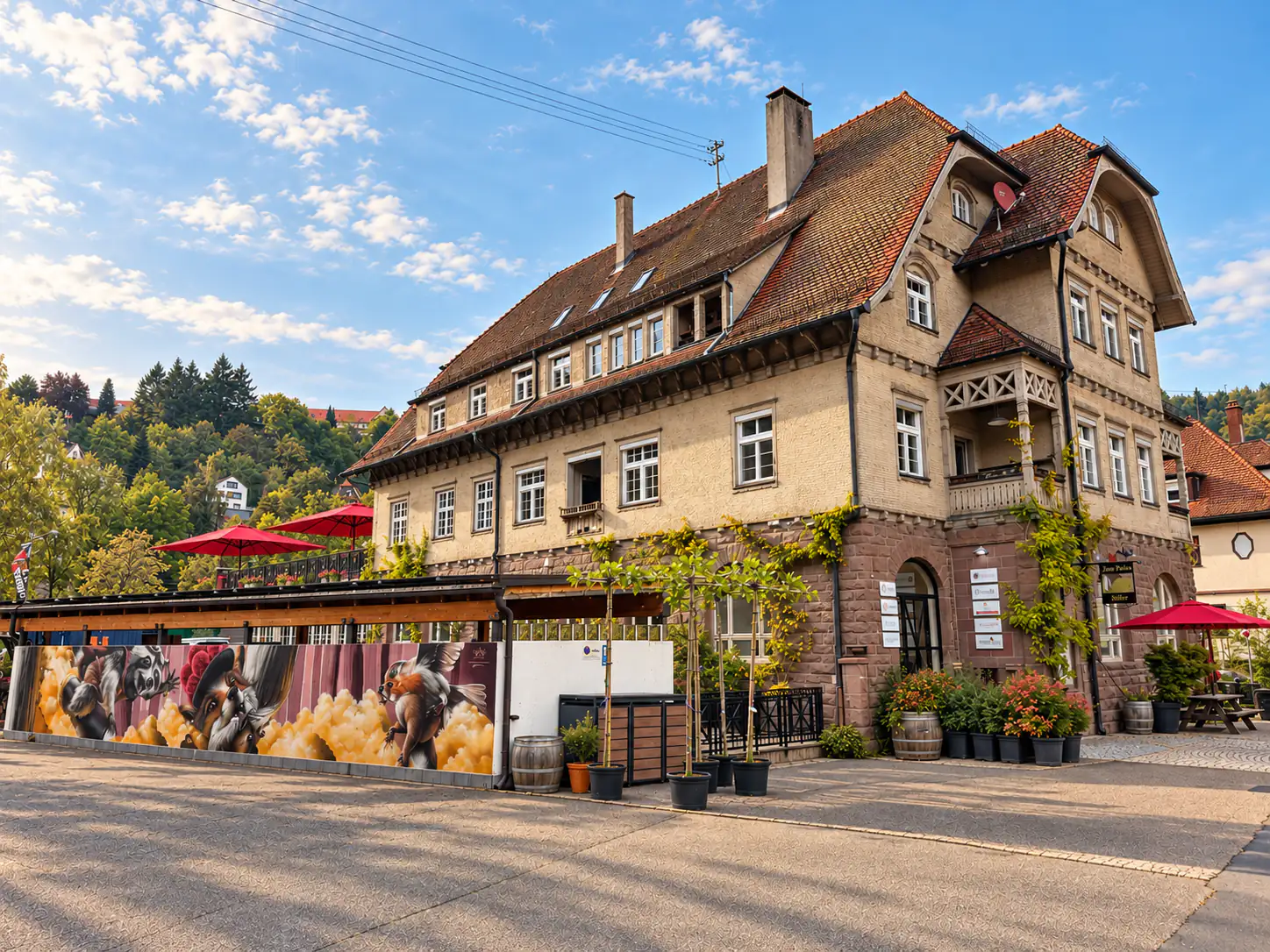 The old post office in Neuenbürg in the northern Black Forest, home of the Black Forest Coworking Club, with terrace and red parasols