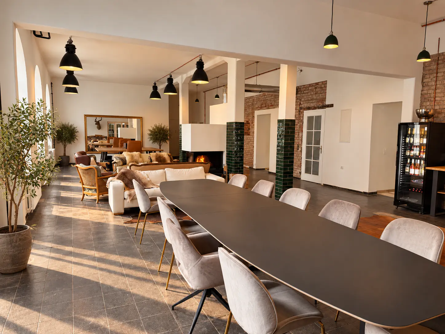 The Black Forest Coworking Club Headquarters: long work table, sofas by the fireplace and bar under high ceilings