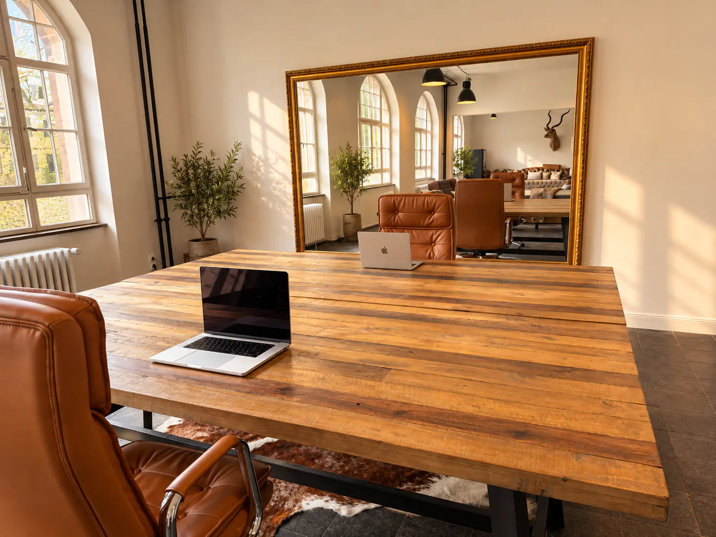 Fixed desk at a wooden table with leather chair and large mirror