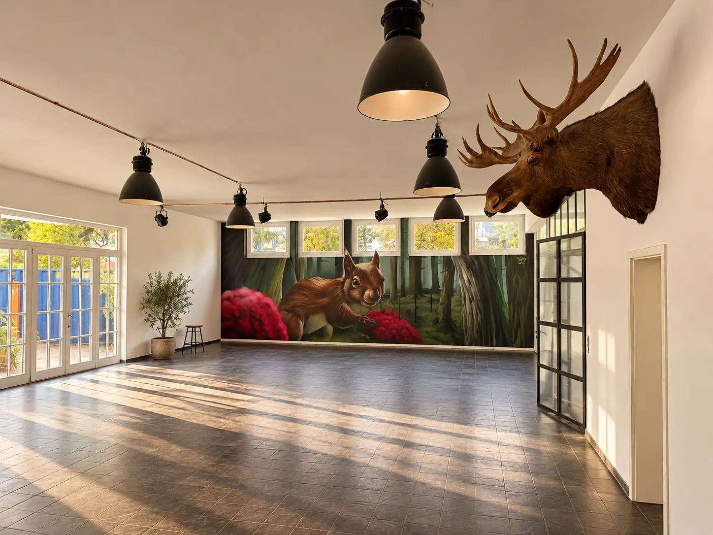 Event hall with a large forest mural and a moose head on the wall